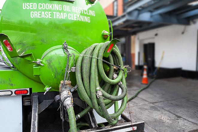 grease trap pumping truck servicing a restaurant in Ammon